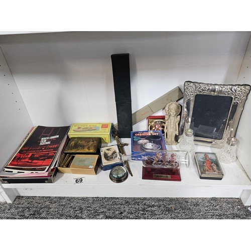 69 - A shelf of collectables to include an art deco style silver plated frame, a collection of engineers ... 