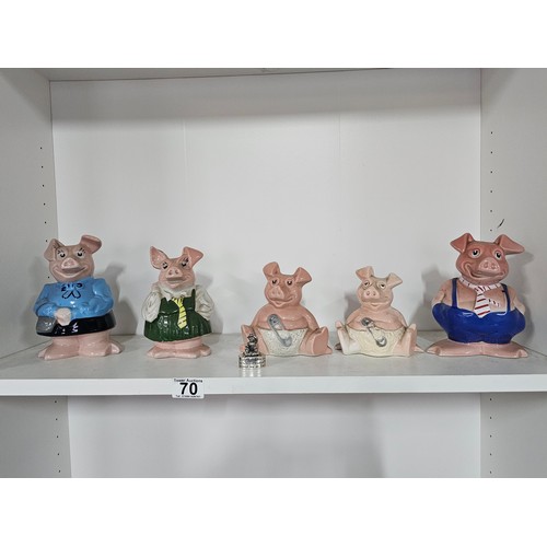 70 - A collection of five Wade pigs to include two babies, mum dad and daughter along with a silver plate... 