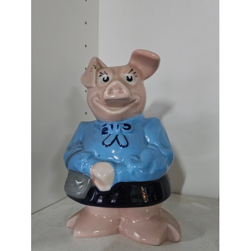 70 - A collection of five Wade pigs to include two babies, mum dad and daughter along with a silver plate... 