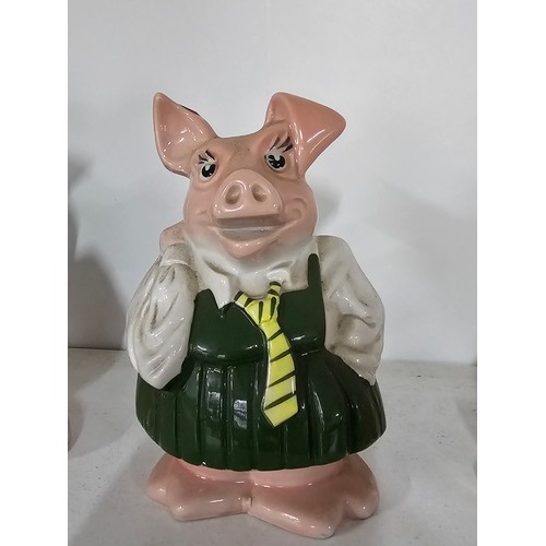 70 - A collection of five Wade pigs to include two babies, mum dad and daughter along with a silver plate... 