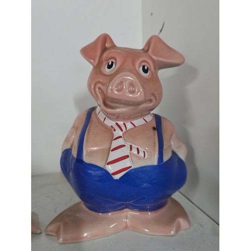 70 - A collection of five Wade pigs to include two babies, mum dad and daughter along with a silver plate... 