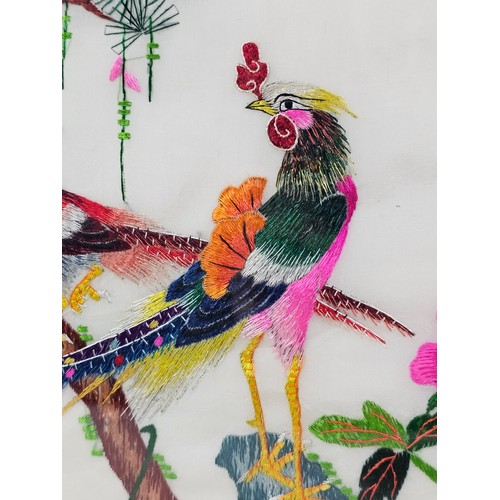 85 - A framed and glazed silk oriental picture depicting 2 golden pheasants n a branch signed to the top ... 