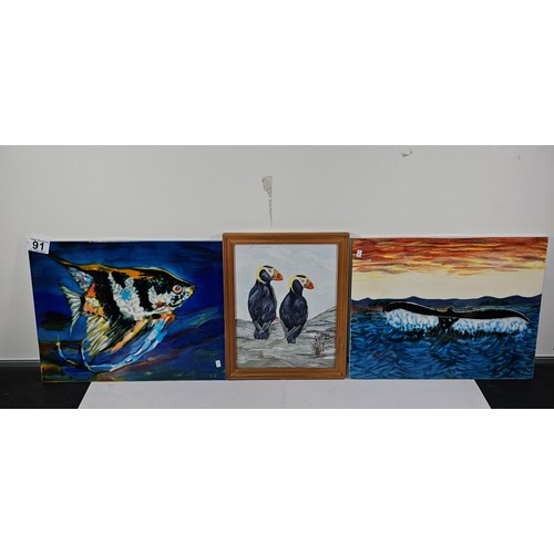91 - A collection of 3 tiled pictures to include a hand painted framed tile picture of 2 puffins signed t... 
