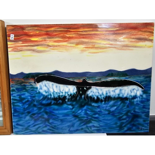 91 - A collection of 3 tiled pictures to include a hand painted framed tile picture of 2 puffins signed t... 