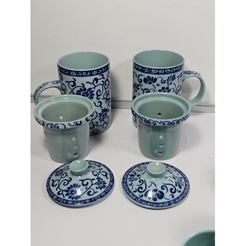 98 - A oriental tea set with a blue floral pattern complete with a teapot with a bamboo handle. Teapot is... 