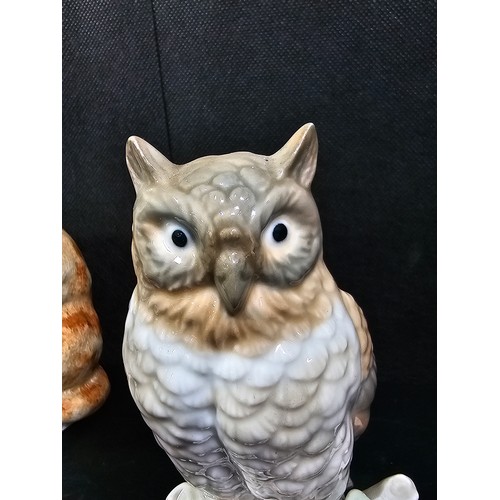 101 - A small collection of figurines to include a white ceramic cat by Beswick stamped 1867, a John Rayfo... 