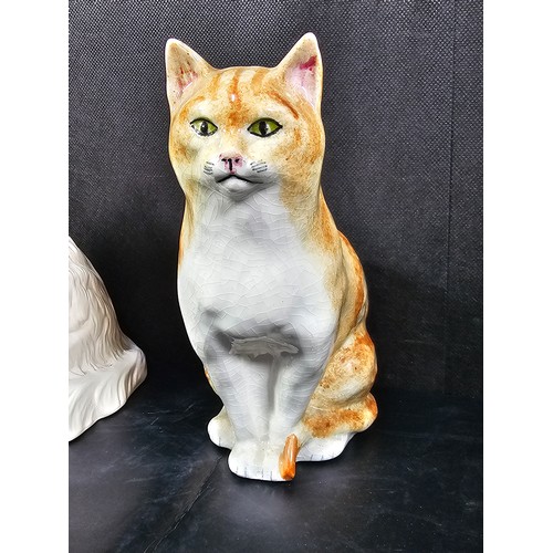 101 - A small collection of figurines to include a white ceramic cat by Beswick stamped 1867, a John Rayfo... 
