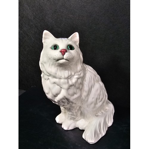 101 - A small collection of figurines to include a white ceramic cat by Beswick stamped 1867, a John Rayfo... 