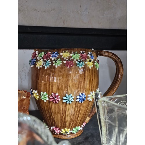 102 - A large quantity of collectables to include an Italian Pottery piece of a lady pushing a Wheelbarrow... 