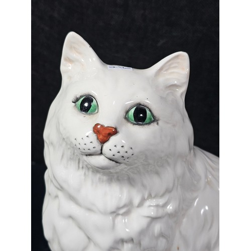 104 - A good quality ceramic Beswick cat figure which is well detailed with green painted eyes stamped 186... 