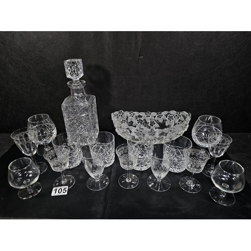 105 - A quantity of glassware to include a cut glass crystal decanter complete with stopper along with 4 g... 