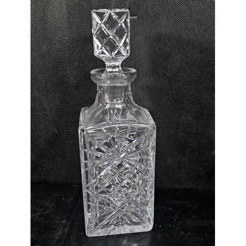 105 - A quantity of glassware to include a cut glass crystal decanter complete with stopper along with 4 g... 