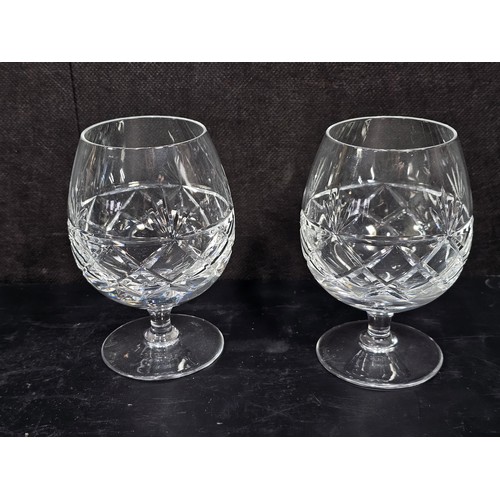105 - A quantity of glassware to include a cut glass crystal decanter complete with stopper along with 4 g... 