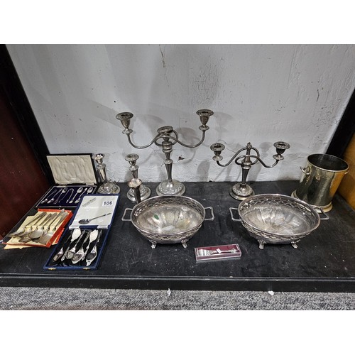 106 - A quantity of silver plated ware to include 2 table top candelabras with 2 matching single stem cand... 