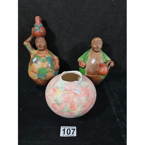 107 - A pair of good quality handmade Peruvian bulbous figures both are hand signed to the base, one of a ... 