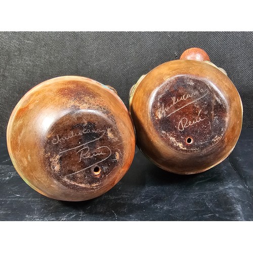 107 - A pair of good quality handmade Peruvian bulbous figures both are hand signed to the base, one of a ... 