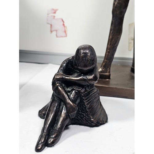 108 - A collection of 4 figurines in resin to include a Ballerina standing by a column, a dancer sitting o... 