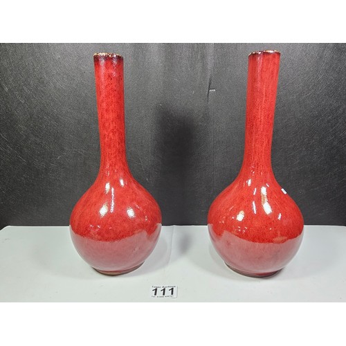 111 - A pair of red bulbous vases both are studio pottery pieces with a mottled design. Both in good order... 