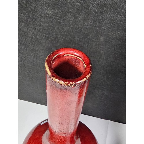 111 - A pair of red bulbous vases both are studio pottery pieces with a mottled design. Both in good order... 