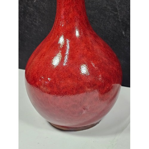 111 - A pair of red bulbous vases both are studio pottery pieces with a mottled design. Both in good order... 