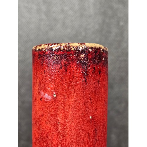111 - A pair of red bulbous vases both are studio pottery pieces with a mottled design. Both in good order... 