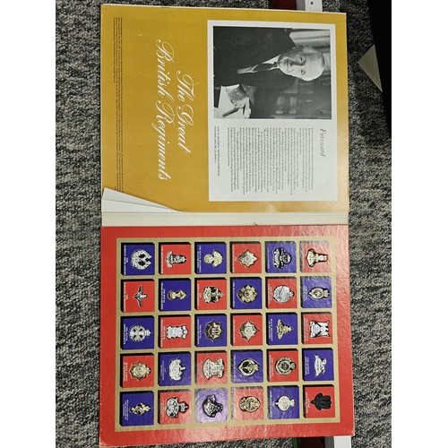 93 - A collection of military and royal related items to include a framed and glazed regimental cap badge... 