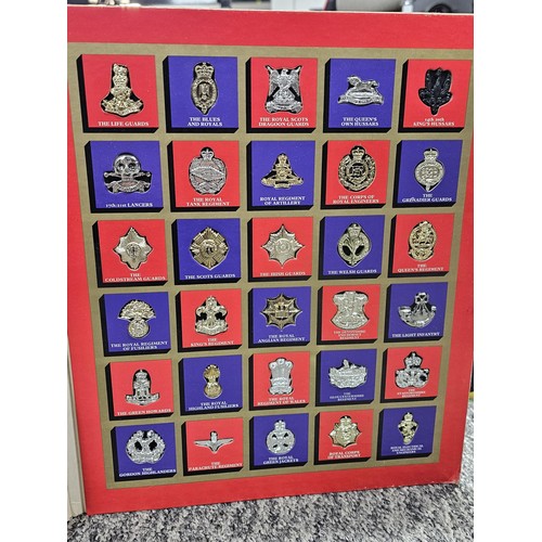 93 - A collection of military and royal related items to include a framed and glazed regimental cap badge... 