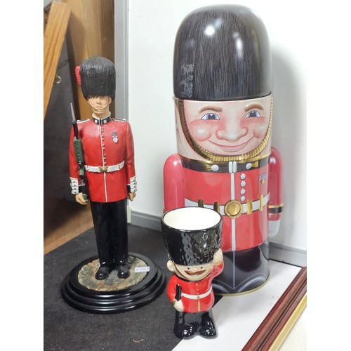 93 - A collection of military and royal related items to include a framed and glazed regimental cap badge... 
