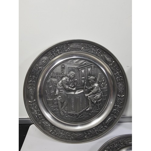 116 - A collection of 8x tin plates each with a different trade design to the front to include Glassblower... 