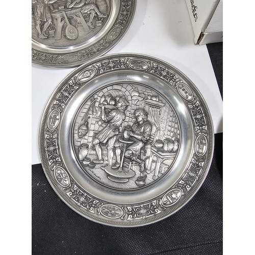 116 - A collection of 8x tin plates each with a different trade design to the front to include Glassblower... 
