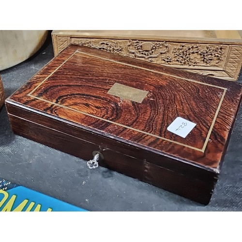 125 - A collection of wooden items to include a hand carved lidded box displaying an image of two people i... 
