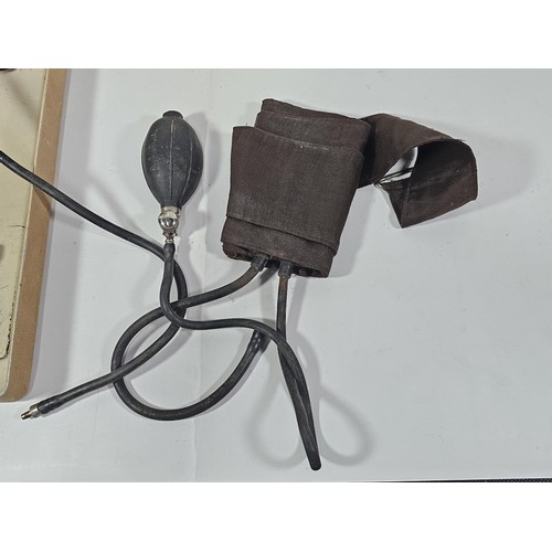 132 - A vintage Zenith A blood pressure monitor kit, appears to be complete with armband and pump, along w... 