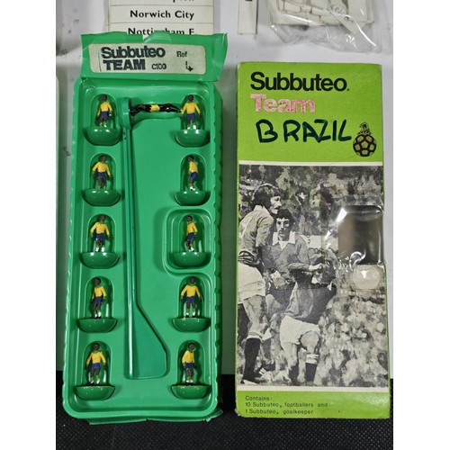 141 - A quantity of Subbuteo items to include a vintage Brazil team which is complete, Manchester United i... 