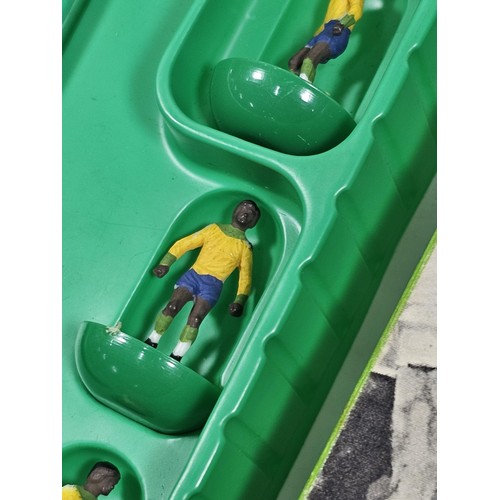 141 - A quantity of Subbuteo items to include a vintage Brazil team which is complete, Manchester United i... 