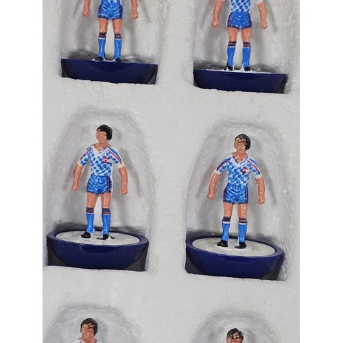 141 - A quantity of Subbuteo items to include a vintage Brazil team which is complete, Manchester United i... 