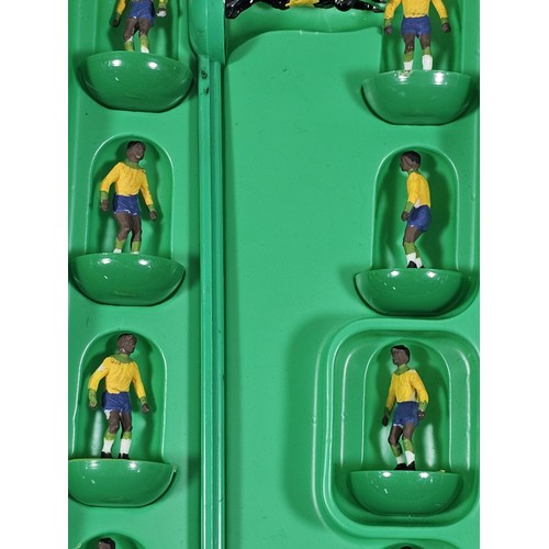 141 - A quantity of Subbuteo items to include a vintage Brazil team which is complete, Manchester United i... 
