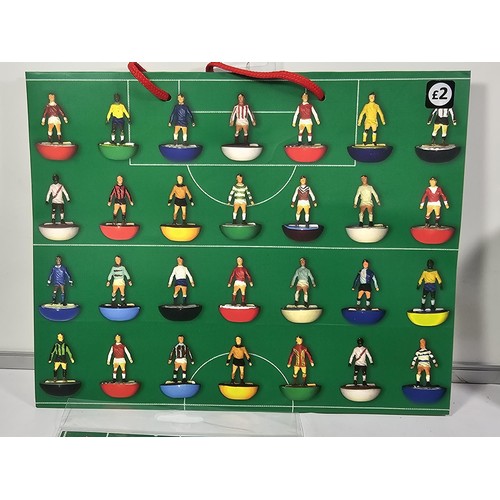 143 - A Flick to Kick history of Subbuteo book along with Subbuteo wrapping paper and matching gift bag, a... 