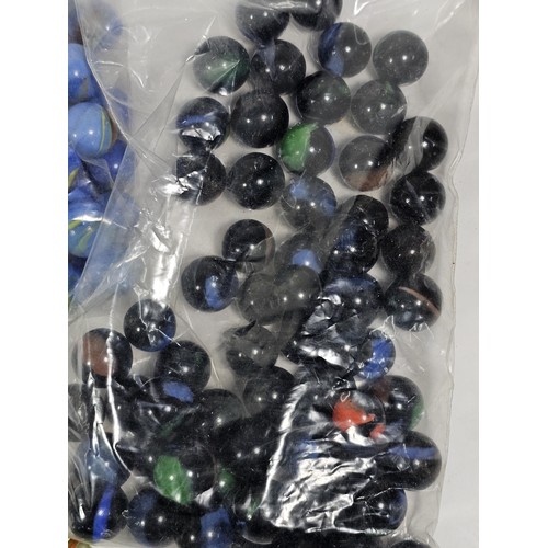 144 - A box containing 8 bags of assorted marbles to include traditional rainbow glass marbles, white marb... 