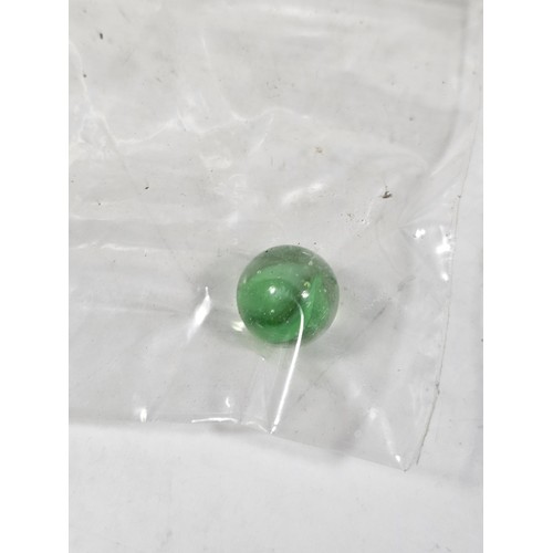 144 - A box containing 8 bags of assorted marbles to include traditional rainbow glass marbles, white marb... 