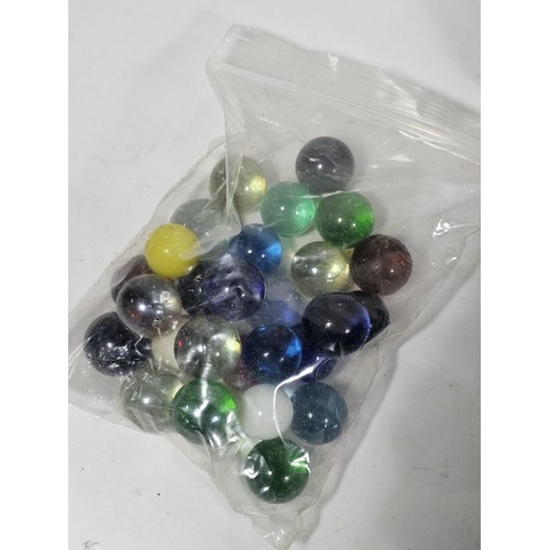 144 - A box containing 8 bags of assorted marbles to include traditional rainbow glass marbles, white marb... 