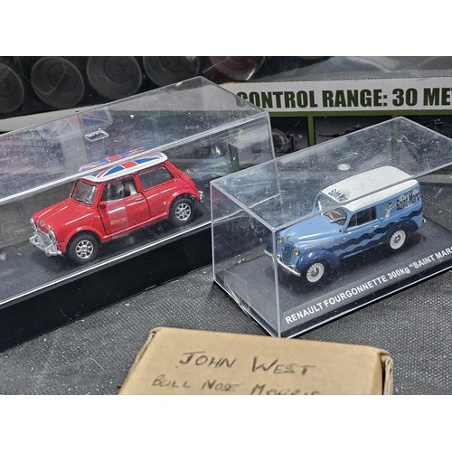 149 - A collection of diecast cars to include 6 cars in perspex cases, a Ferrari, Mini, Fiat Punto rally c... 