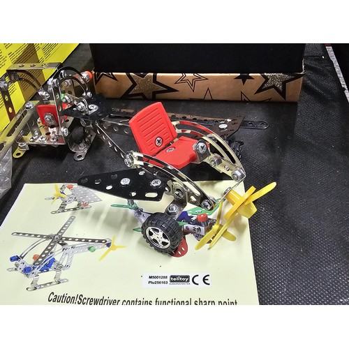 150 - A box containing a quantity of Meccano style Metal Toy pieces complete with instructions for 5x diff... 