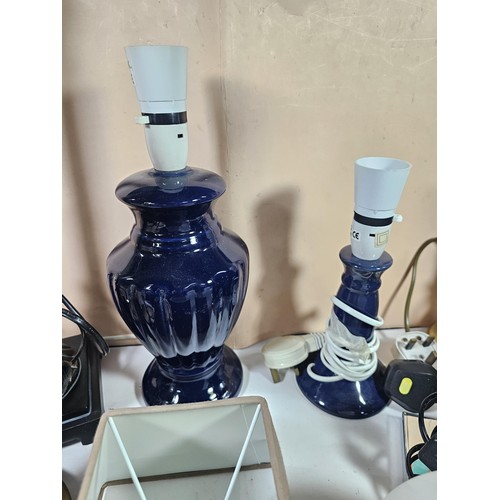184 - A box containing a large quantity of lights and light fittings to include 2 ceramic lamps, a bulkhea... 