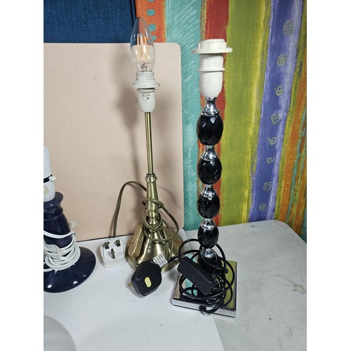 184 - A box containing a large quantity of lights and light fittings to include 2 ceramic lamps, a bulkhea... 