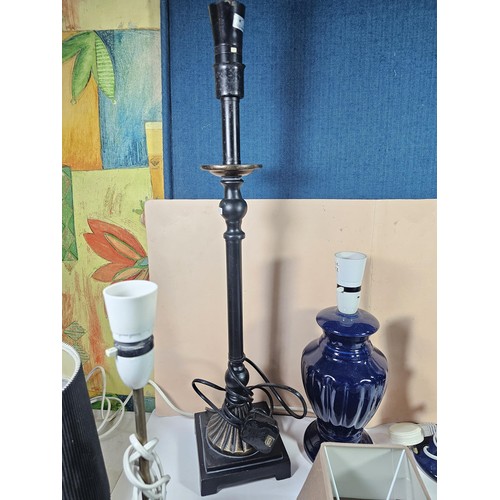 184 - A box containing a large quantity of lights and light fittings to include 2 ceramic lamps, a bulkhea... 