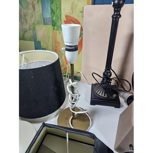 184 - A box containing a large quantity of lights and light fittings to include 2 ceramic lamps, a bulkhea... 