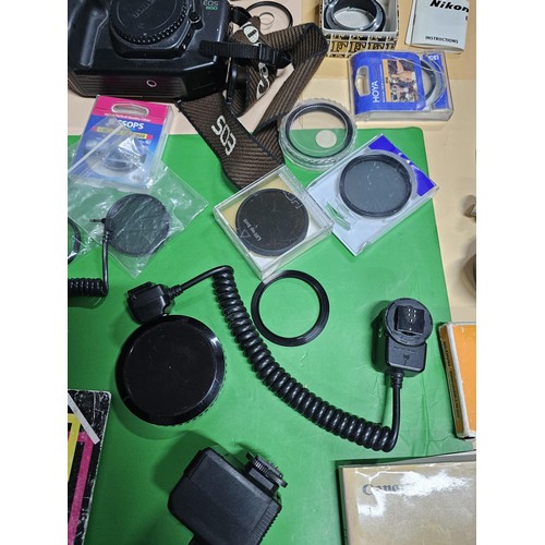 165 - A large quantity of photographic related items to include a Cannon EOS 600 camera along with and ass... 