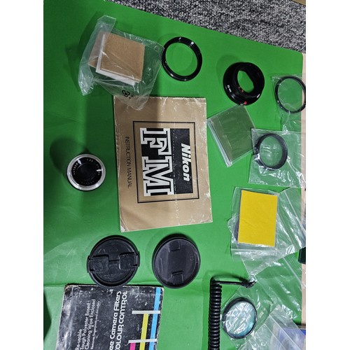 165 - A large quantity of photographic related items to include a Cannon EOS 600 camera along with and ass... 