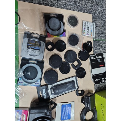 165 - A large quantity of photographic related items to include a Cannon EOS 600 camera along with and ass... 