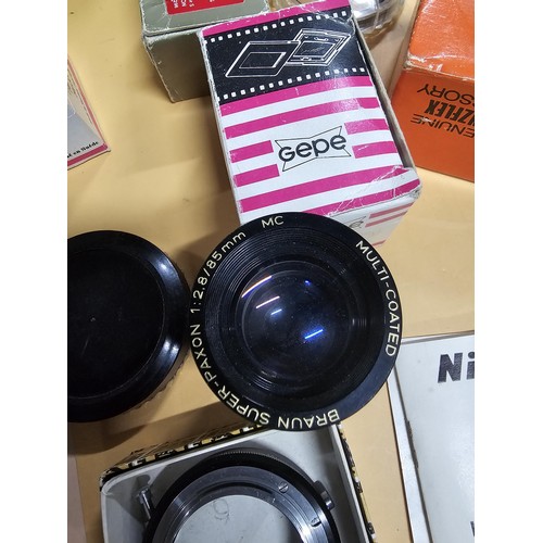 165 - A large quantity of photographic related items to include a Cannon EOS 600 camera along with and ass... 